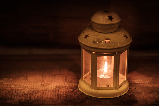 Retro style lantern with a candle at night
