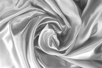 folds satin silk fabric in the form of a curl. Satin background. toned.