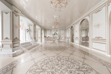 Luxurious vintage interior with fireplace in the aristocratic style. Large Windows and mirrors....