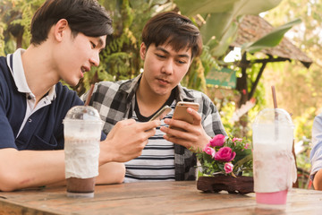 People adding friend play social media with smartphone together in coffee shop