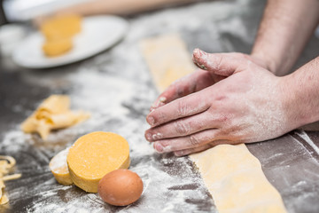 Chef's hands prepares Italian food stuffed pasta ravioli