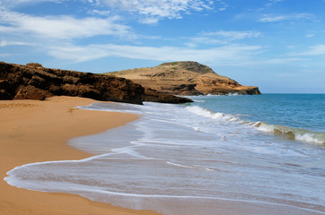 Colombia, wild coastal desert of Penisula la Guajira near  the Cabo de la Vela resort.  Pilon de Azucar beaches of the Caribbean coast with turquoise water and orange sand