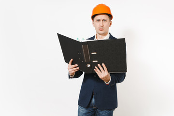 Exhausted dissatisfied businessman in dark suit, protective construction helmet holding black folder for papers document isolated on white background. Male worker for advertisement. Business concept.
