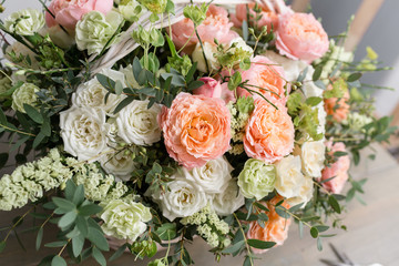 Beautiful flower composition a bouquet in a wicker basket. Floristry concept. Spring colors