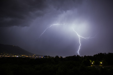 Fototapeta na wymiar lightning over city