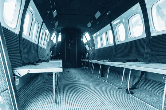 Interior of transport aircraft for parachute jump, View to the cabin with seats for people.. Turbolet transport aircraft for parachute jump