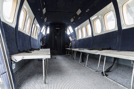 Interior of transport aircraft for parachute jump, View to the cabin with seats for people.. Turbolet transport aircraft for parachute jump