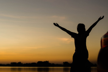 Fototapeta premium The silhouette of women is holding hands happily.