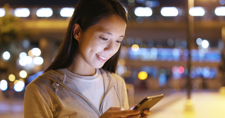 Woman use of smart phone at night