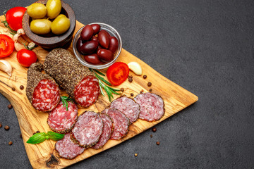 Dried organic salami sausage on wooden cutting board