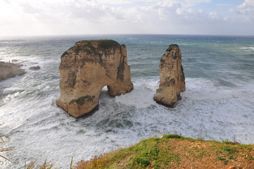 Pigeon Rocks in Raouche, Lebanon. mediterranean sea and beautiful stone mountains in water. nature and environment. wanderlust and traveling to middle east. Raouche rocks or pigeon mountains.