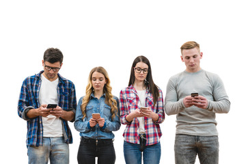 Obraz premium The four friends with phones stand on the white wall background