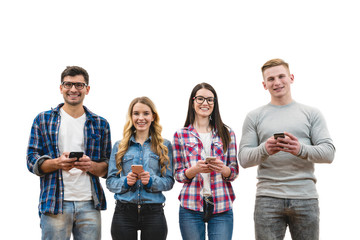 Fototapeta premium The four happy people with phones stand on the white wall background