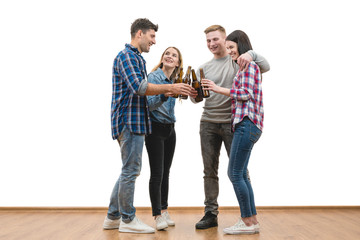 Fototapeta premium The four people drink a beer on a white wall background