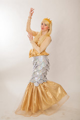 Fototapeta premium A young girl in a chic suit of a sea mermaid. Theatrical costume
