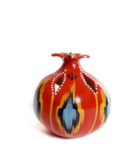 traditional Uzbek ceramicpomegranate with ornament Ikat on white background