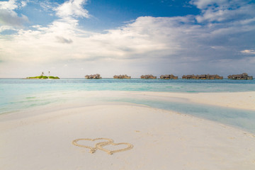 Fototapeta na wymiar Luxury Maldives resort and island beach view. White sand and water villas