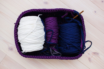 Coils of ribbon yarn in the handmade basket