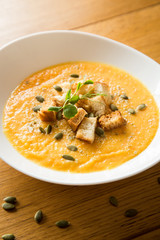 Pumpkin soup on wood table
