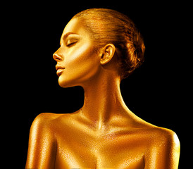 Fashion art golden skin woman portrait closeup. Gold, jewelry, accessories. Model girl with golden glamour shiny makeup