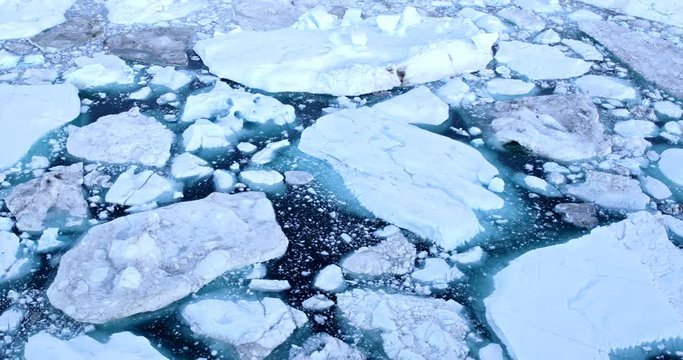 Climate Change and Global Warming - Icebergs and from melting glacier in icefjord in Ilulissat, Greenland. Aerial video of arctic nature ice landscape.
