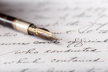 Fountain pen on an antique handwritten letter