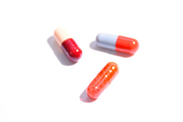 Different colorful  pills on white background