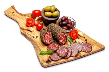 Dried organic salami sausage on wooden cutting board