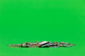 Various Coins in a Pile, Centre - Isolated on a Bright Green Background