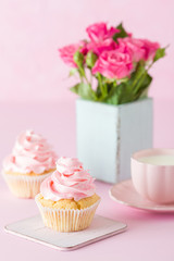 Pink pastel vertical banner with decorated cupcakes, cup of coffe with milk and bouquet of pink roses.