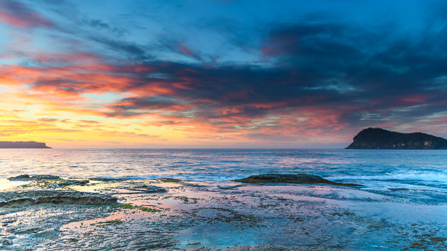 Vibrant Sunrise Seascape with Clouds and Island