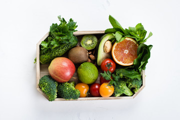 Healthy Food Clean Concept. Raw fruits, Vegetables, Nuts, Cereals in wooden Tray on Concrete Stone Table Background. Top view