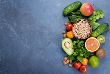 Healthy Food Clean Concept. Raw fruits, Vegetables, Nuts, Cereals on Concrete Stone Table Background. Top view, copy space