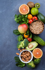 Healthy Food Clean Concept. Raw fruits, Vegetables, Nuts, Cereals on Concrete Stone Table Background. Top view