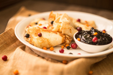 Jam and berries with pancakes
