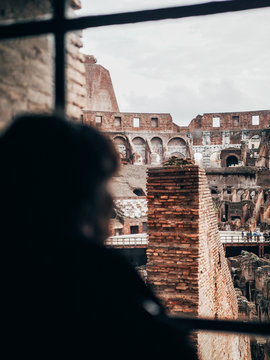 Person looking at ruins from window