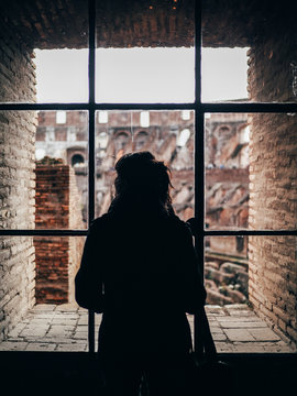 Person looking at ruins from window