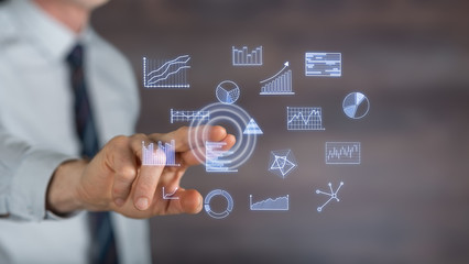 Man touching business charts on a touch screen
