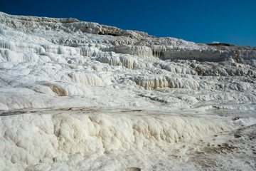 Fototapeta na wymiar Lime mountains travertine in places of geothermal source outlet, Pamukkale Turkey.