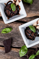 Ice cream, Chocolate ice cream scoop in waffle cone on wooden background.