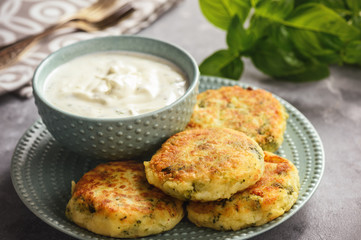 Broccoli and potato cutlets with cheese and yogurt dip.