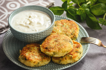 Broccoli and potato cutlets with cheese and yogurt dip.