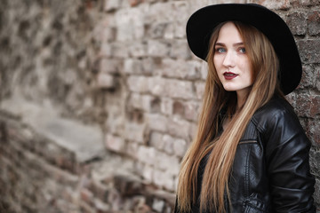Young beautiful girl in a hat and with a dark make-up outside. G