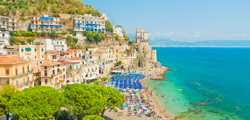 panoramic view of small european town and people on beach