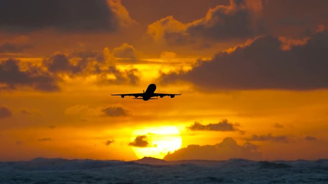 Aircraft flying over amazing tropical ocean at sunrise. Dominican Republic travel destinations.