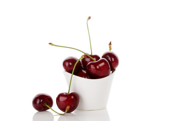 Delicious cherries in cup isolated.