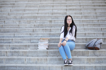 Girl student on the street with books