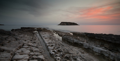 Rocky Seascape with dramatic beautiful sunset