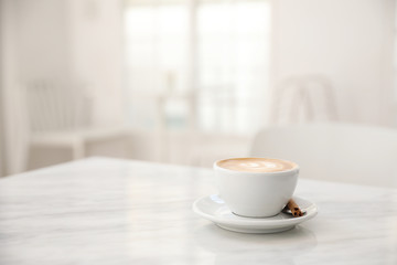 Fototapeta na wymiar Cappuccino coffee cup on white marble table
