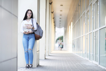 Girl student on the street with books